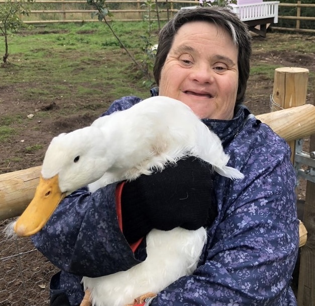 One of the people we support holding a goose outside