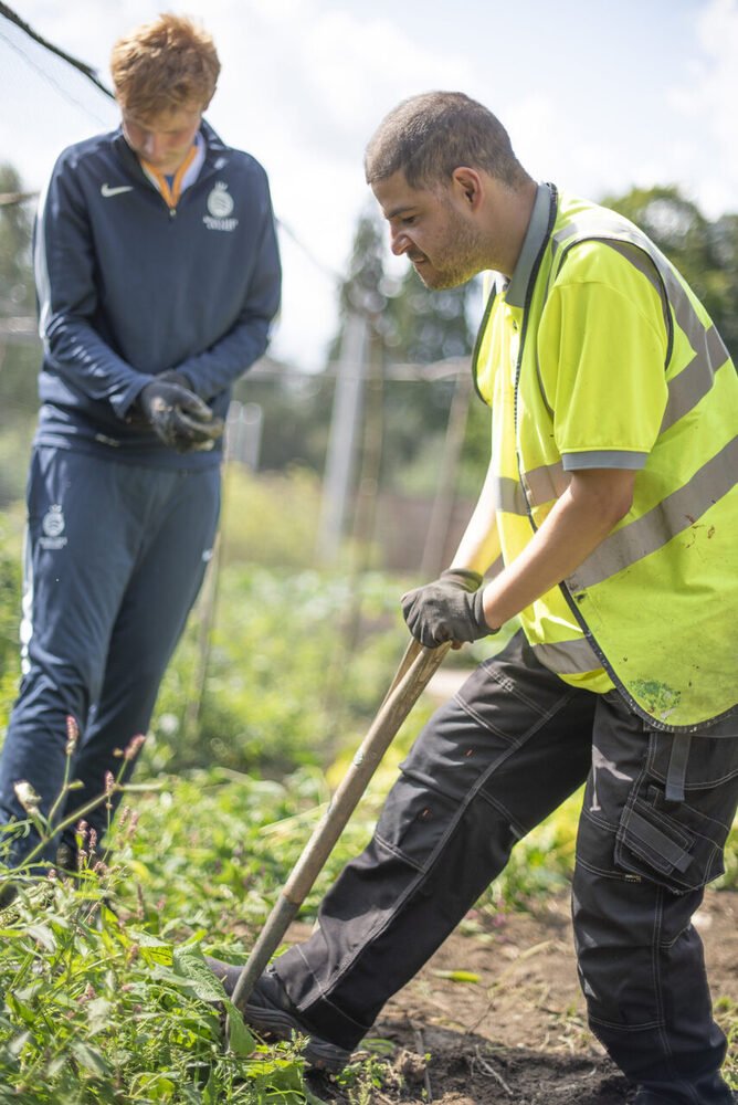 2 people we support gardening in our social farm