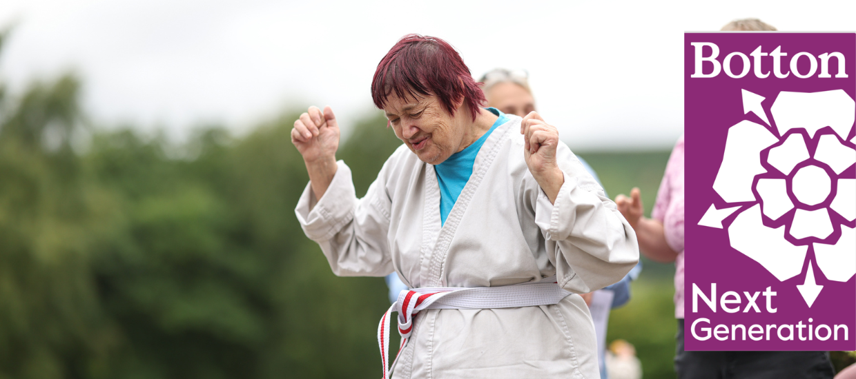 A person dancing in a karate outfit